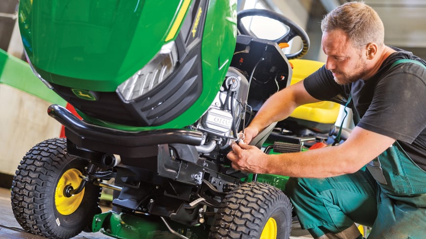 riding lawn mower being repaired by a Koenig Equipment service tech